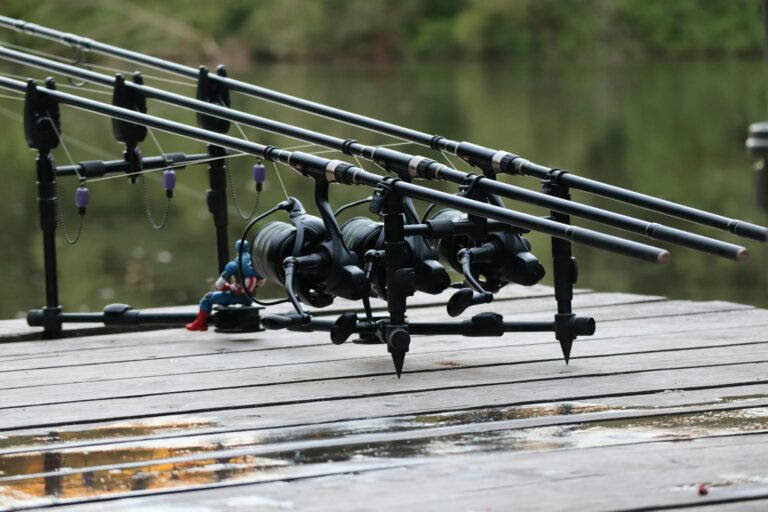 Fishing rods set up on a pier by a tranquil river in Fougères, Brittany, France. Ideal for angling enthusiasts.